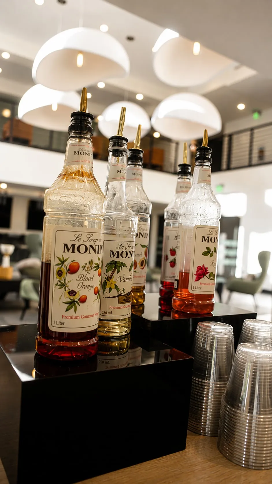 A beverage and coffee bar station with syrups and cups